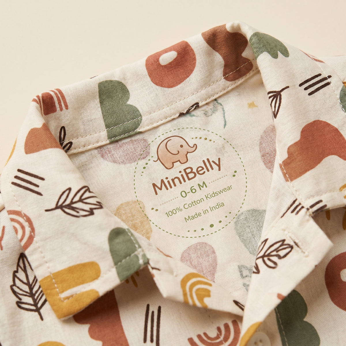 MiniBelly kids' co-ord set with half shirt and pants featuring abstract shapes and leaves in earthy tones, made of soft cotton.