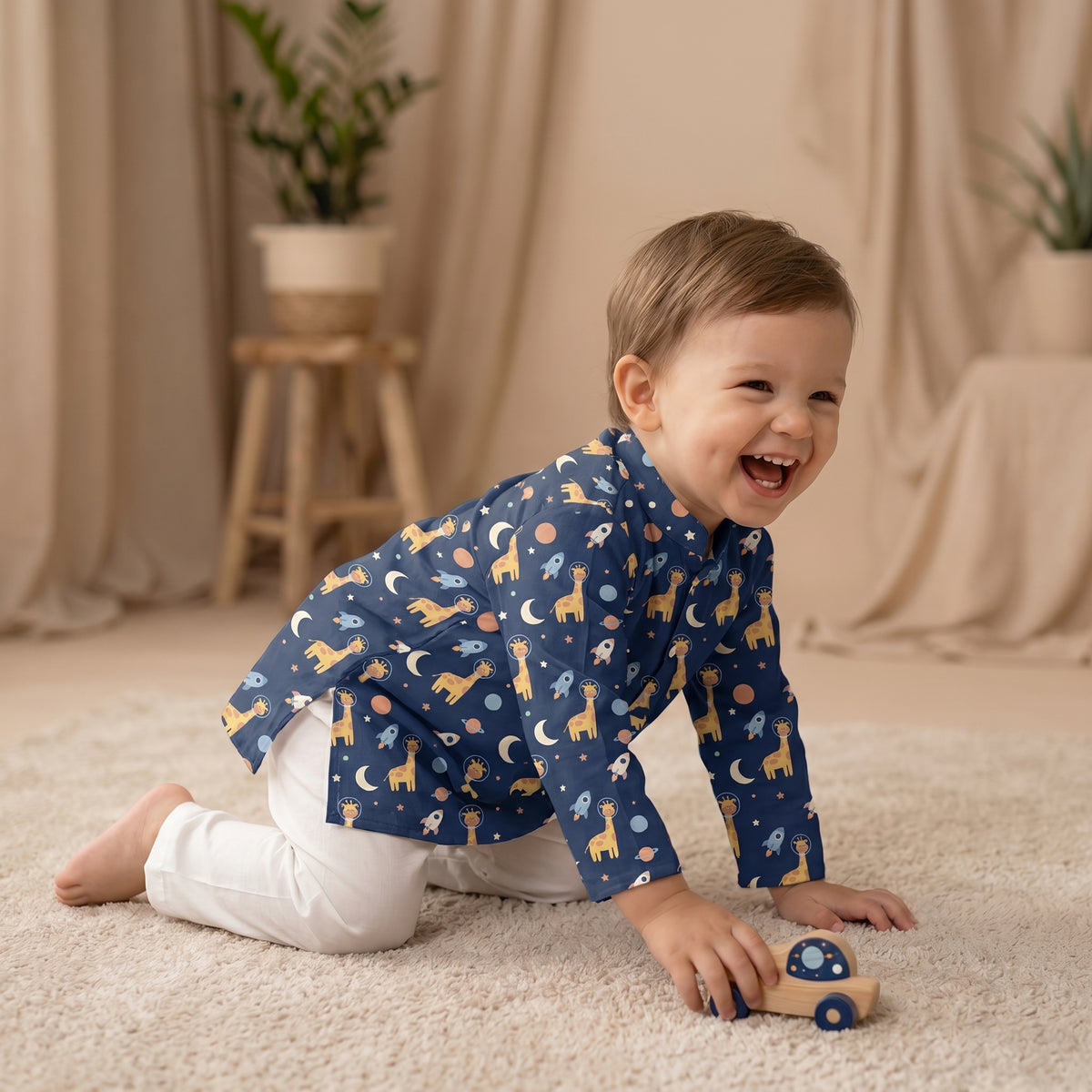 MiniBelly kids' cotton kurta pajama set with cute cartoon astronaut giraffes, rockets, and planets in soft cream stripes.