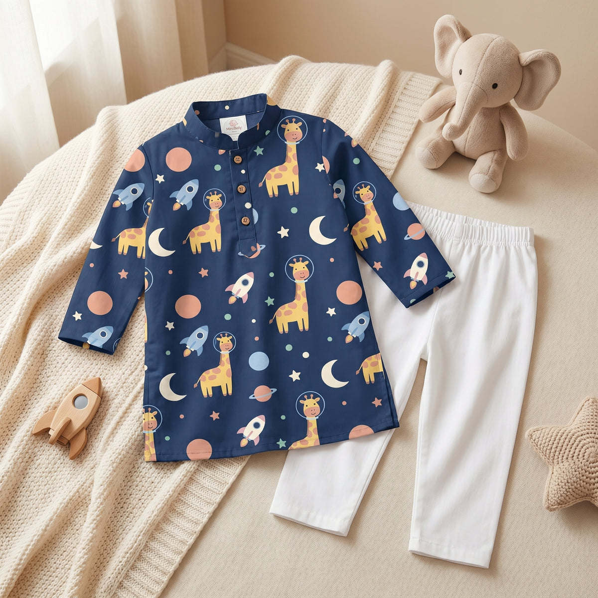 MiniBelly kids' cotton kurta pajama set featuring cute cartoon astronaut giraffes, rockets, and planets in soft striped cream fabric.