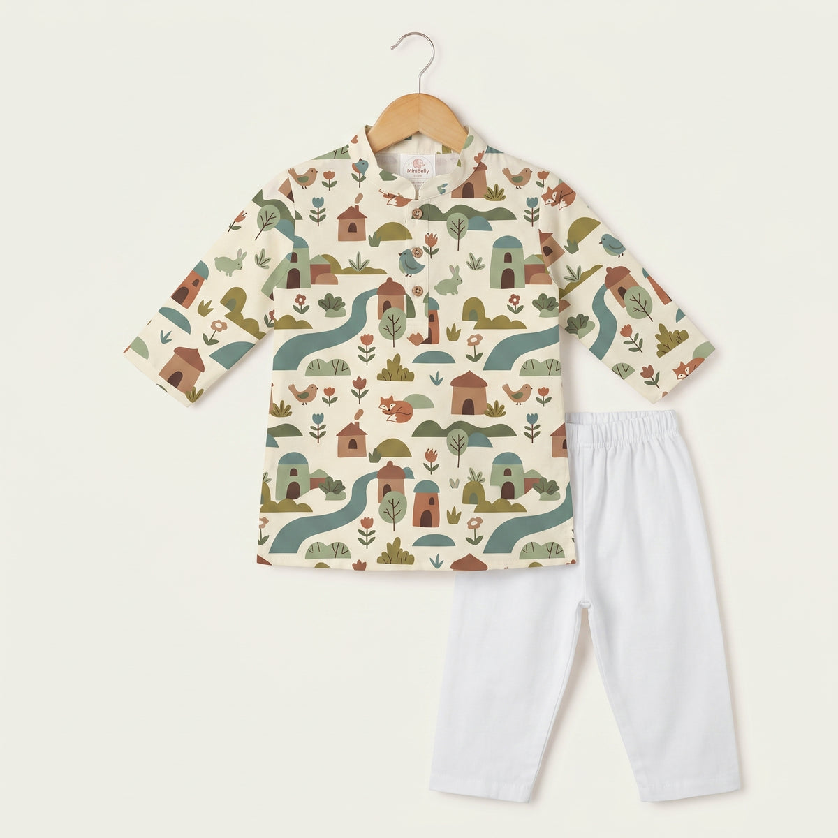 MiniBelly kids' cream cotton kurta pajama set with soft striped fabric featuring whimsical woodland village with animals and houses.