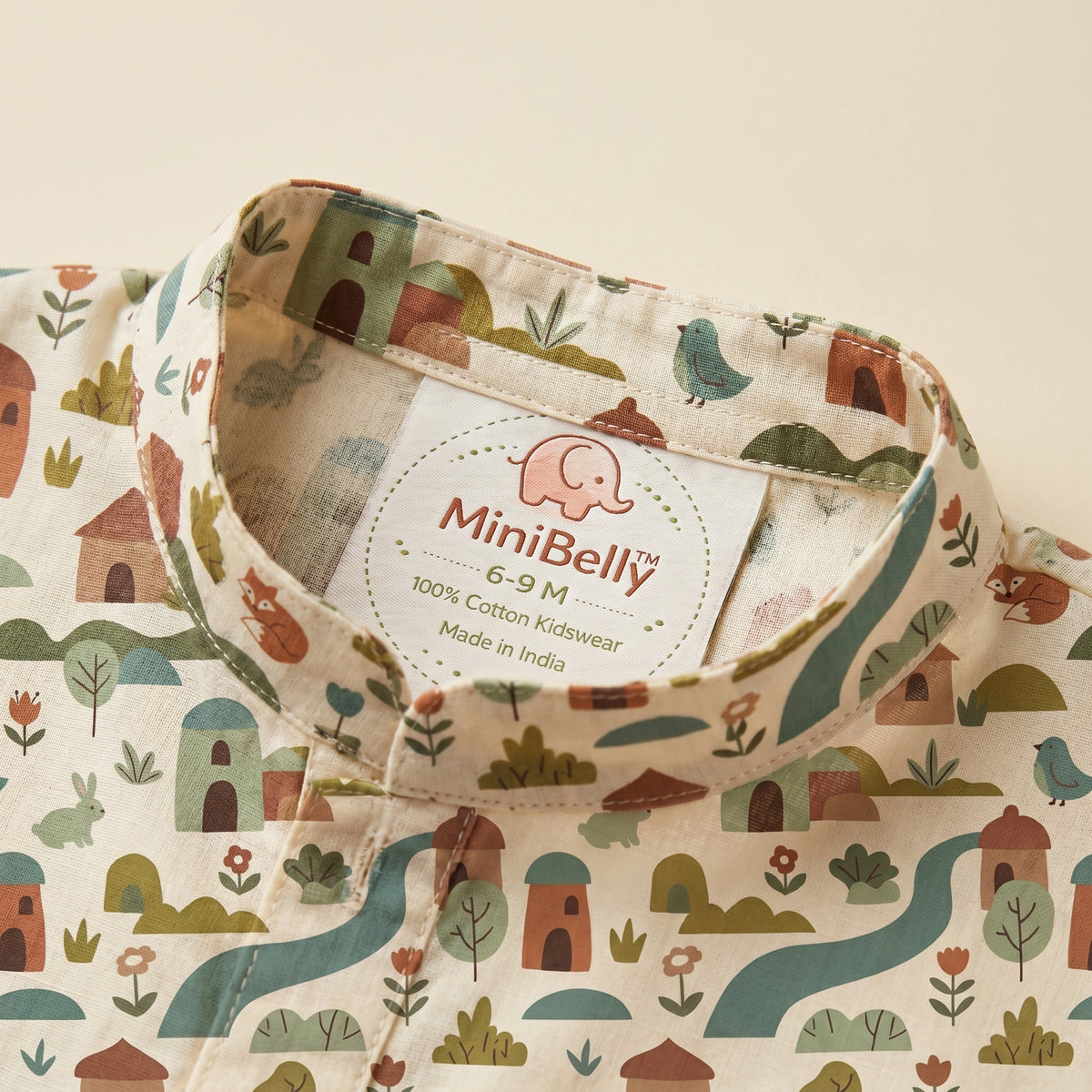 MiniBelly kids' cream cotton kurta pajama set with soft striped fabric featuring whimsical woodland village with animals and houses.