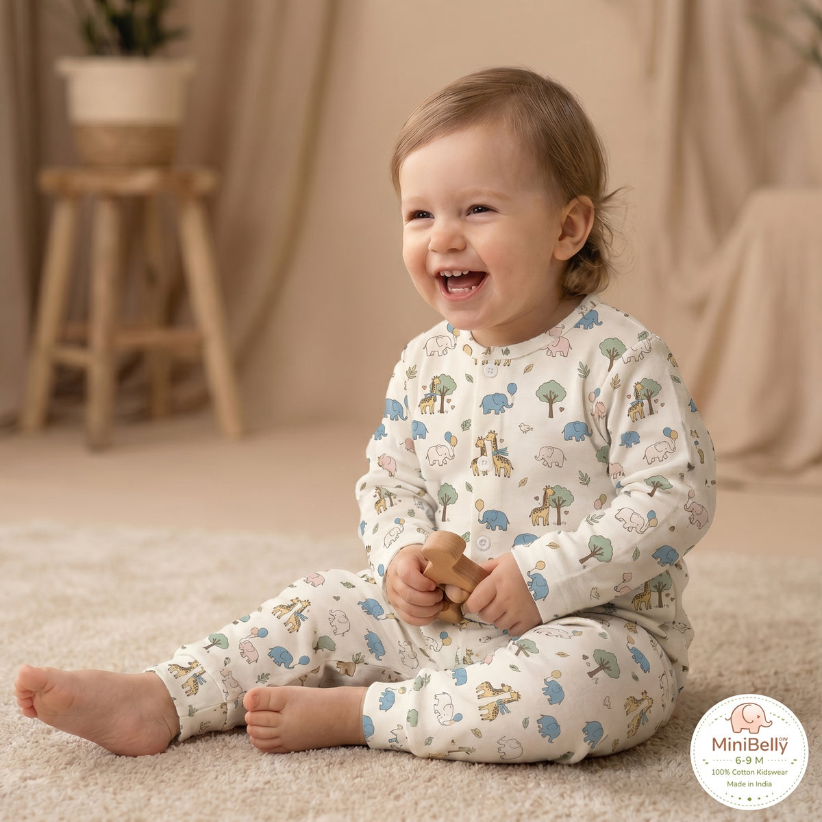 MiniBelly kids' night suit with cute cartoon elephants, giraffes, balloons, and trees in cream cotton fabric for babies 0-6 months.